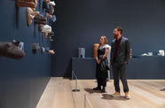 Two people looking at art in a gallery