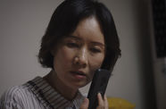 A Korean Woman holds her phone to her ear