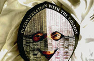 Photo of David Medalla wearing a mask that reads "in conversation with the cosmos"
