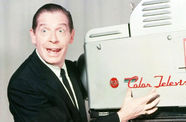 Milton Berle poses next to a color telestrator