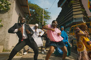 A group of people dancing on a city street