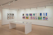 installation image of works on paper framed on walls