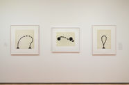 installation image of works on paper framed on walls
