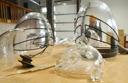 Blown glass shapes, through which is visible a distorted view of the artist