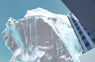 Animated rendering of an iceberg hovering between high-rise buildings