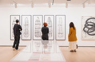 Gallerygoers looking at artworks