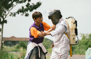 Film still featuring two figures, one wearing a homemade astronaut costume