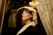 A fashionable woman wearing a hat and a black dress