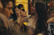 a young man holding another young woman in a bar