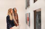 Two women looking at an artwork