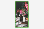 Photo of a tablescape including a wine glass and flower arrangement