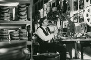 Black and white photo of Bob Rosen inspecting a reel of 35mm film