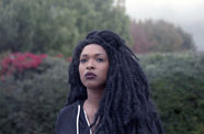 Film still of a Black woman with braids