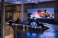 Gallery view of visitors watching a video with an overturned car