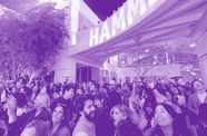 A crowded museum courtyard full of smiling, dancing visitors