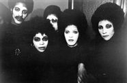 black and white still from hi mom of group with white face paint staring into camera