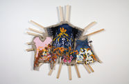 Multicolored material hanging on approx. 16 wood bars