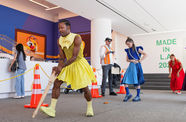 Brightly dressed dancers in the lobby of the Hammer Museum