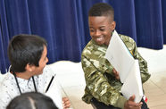 image of boy showing his journal to classmate