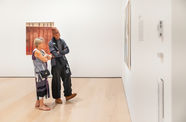 Two museumgoers look at a work of art