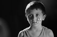 A boy with a bandage on his cheek
