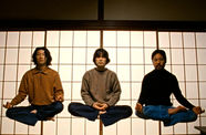 Three figures levitating while sitting cross-legged