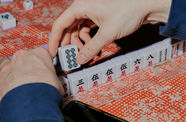 Close up of hands playing mahjong