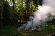 A wall of yellow speakers, surrounded by smoke