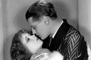 Black and white image of a man and woman embracing