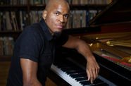 Joshua White sitting at a piano