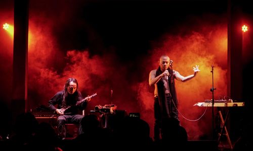 Photo of the musical duo Senyawa performing on stage.