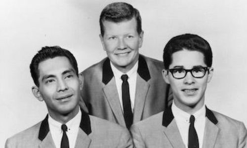 Black and white image of three men in matching suits