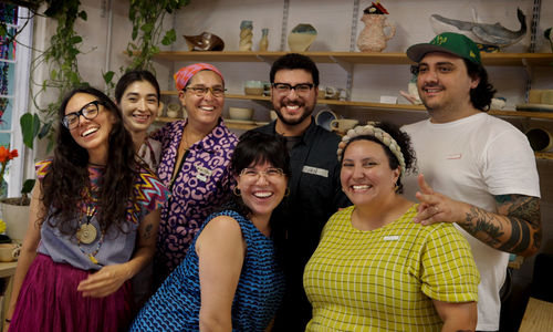 Photo of seven artists in a studio
