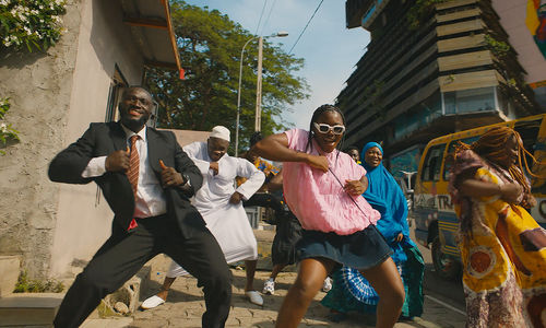 A group of people dancing on a city street
