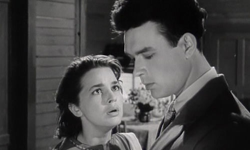 a young lady looking at another young man in suit