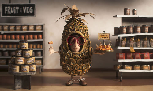 Animation still of an elderly person wearing a pineapple costume, holding a tray of fruit samples