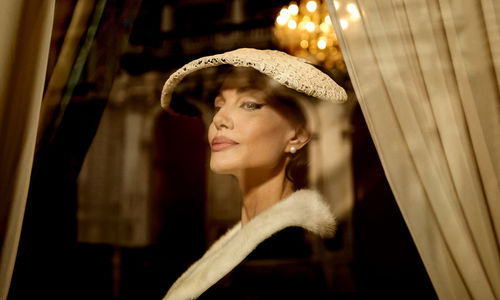 A fashionable woman wearing a hat and a black dress