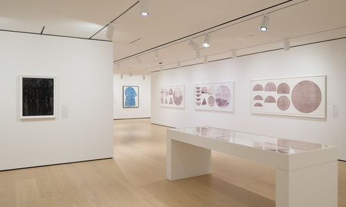 Installation view of framed works installed on wall