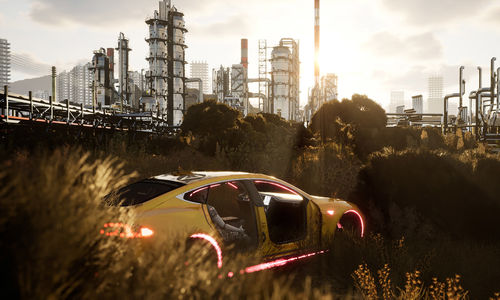 A dismantled yellow sportscar sits in a field