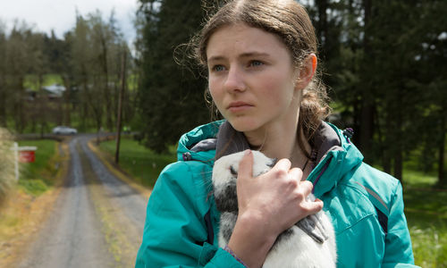 A young girl holds a bunny