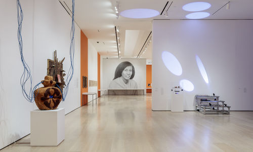 Installation view of a gallery with a large-scale photograph of Alice Coltrane