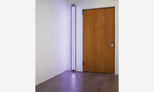 A photo of a door with a purple fluorescent light beside it