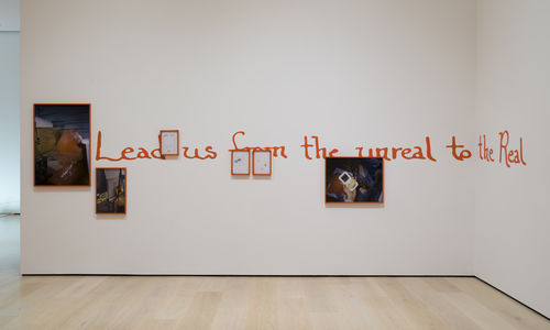 Artwork consisting of a number of framed photographs and watt text reading "Lead us from the unreal to the Real"