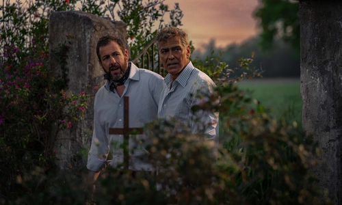 Adam Sandler and George Clooney look off-screen