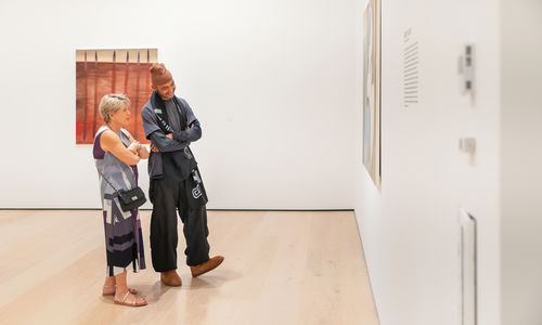 Two museumgoers look at a work of art