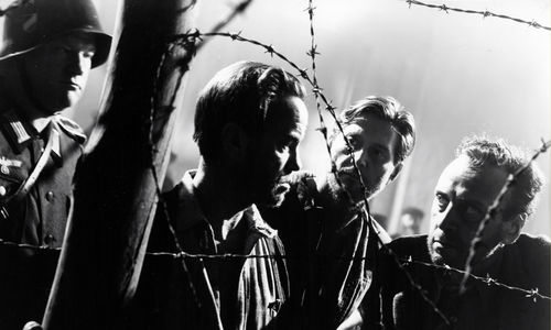 Prisoners behind a barbed wire fence