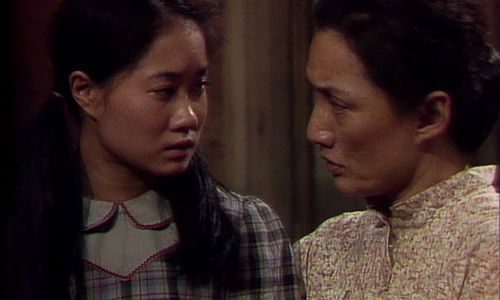 A woman and girl look at each other