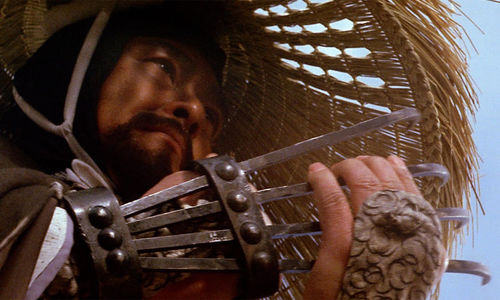 Extreme close up of a man with a metal claw attached to his hand