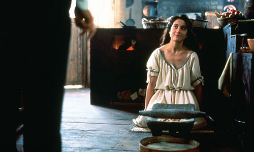 A woman kneels on the floor