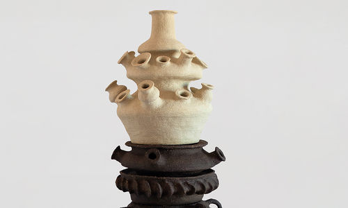 Large, stacked ceramic in black and white with multiple mouth/earpieces